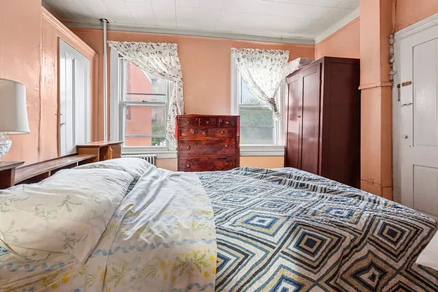 a bedroom with a large bed and a window