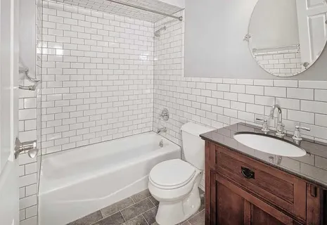 a bathroom with a sink a toilet and bathtub