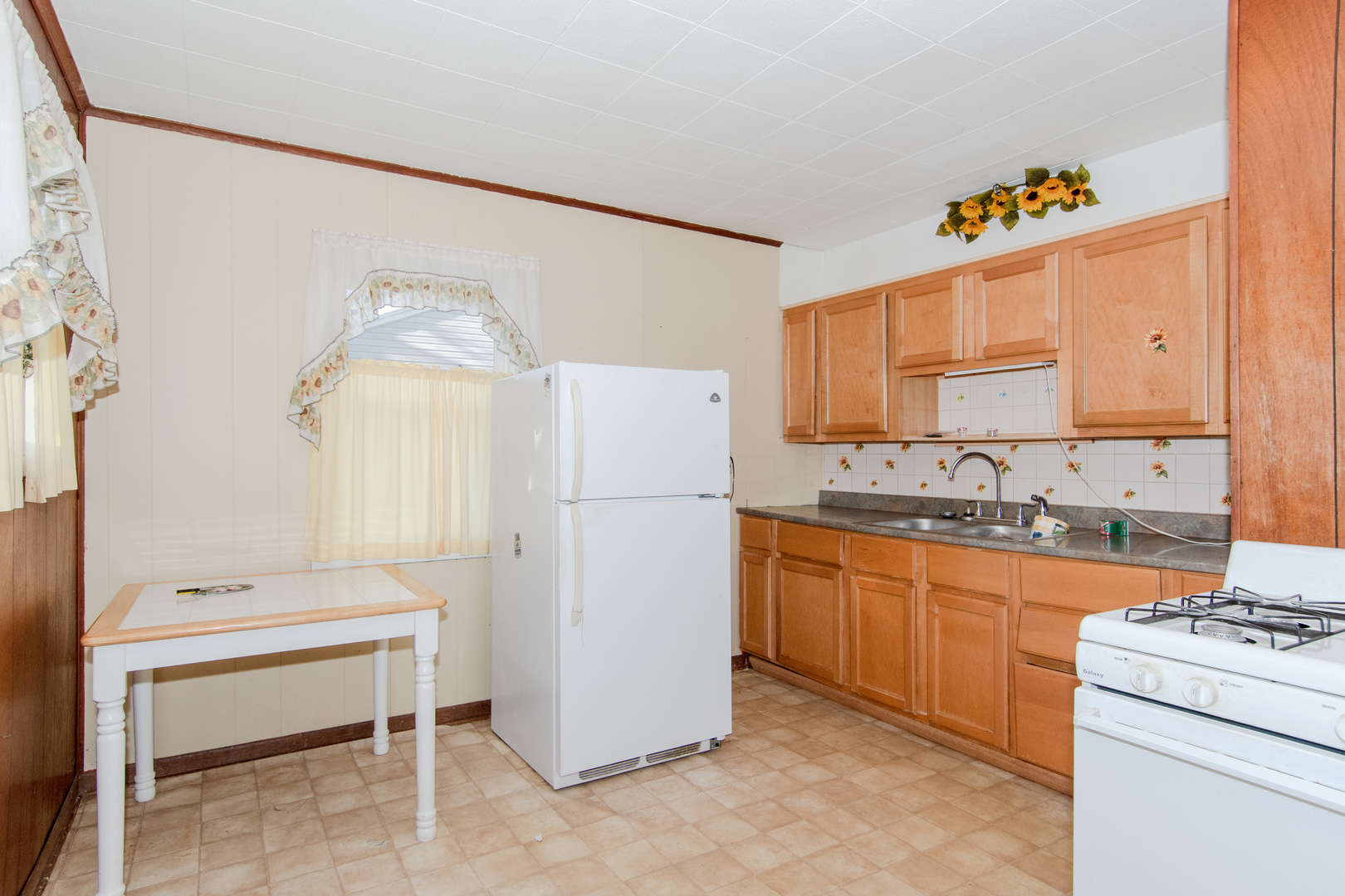 306 Luana Road Joliet, IL 60433 - Photo 13 of 25 a kitchen with granite countertop a white refrigerator stove and sink