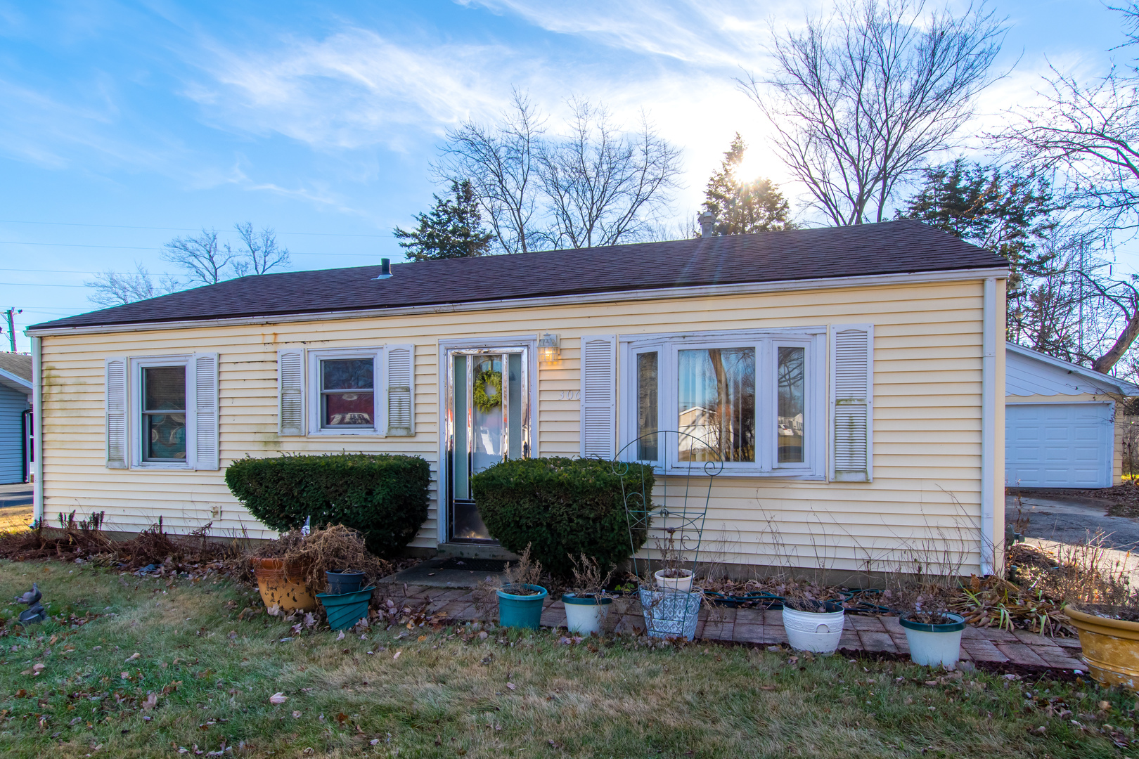 306 Luana Road Joliet, IL 60433 - Photo 3 of 25 a front view of a house with garden and plants