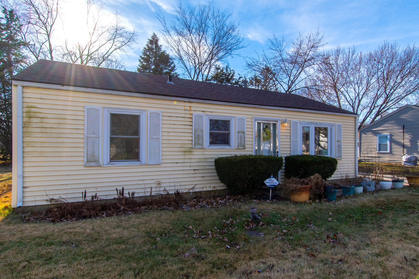306 Luana Road Joliet, IL 60433 - Photo 4 of 25 a backyard of a house with potted plants and large tree