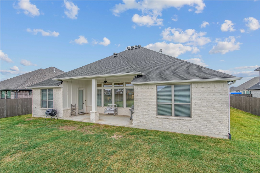 4309 Batona Court Bryan, TX 77802 - Photo 27 of 29 Back of house featuring a fenced backyard, a ceiling fan, a patio, and roof with shingles