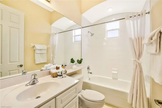 a bathroom with a sink mirror toilet and bathtub