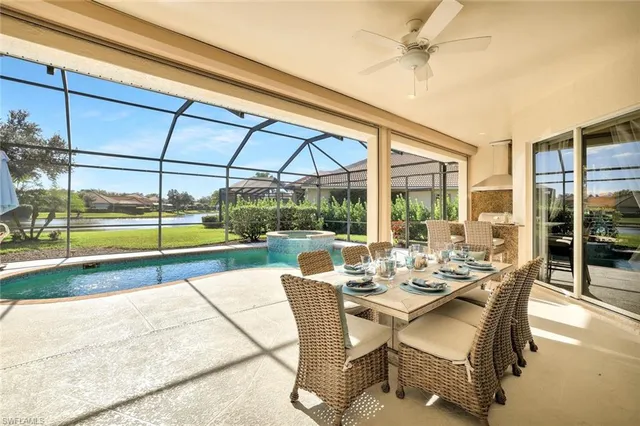 a view of a patio with a table chairs and a backyard