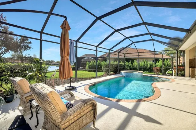 a view of backyard with swimming pool and outdoor seating