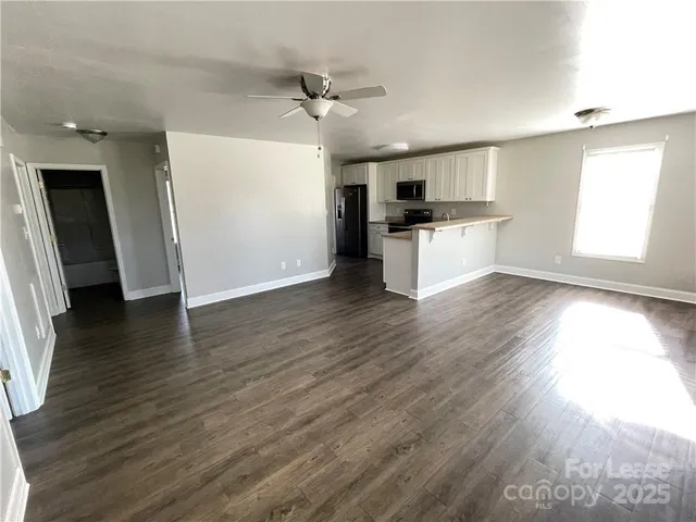 a view of kitchen with refrigerator microwave and stove