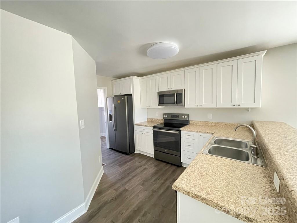 26 East J Street Maiden, NC 28650 - Photo 3 of 12 a kitchen with granite countertop a refrigerator stove and sink