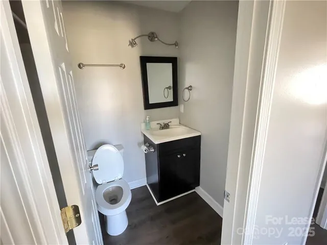 a bathroom with a toilet and a mirror