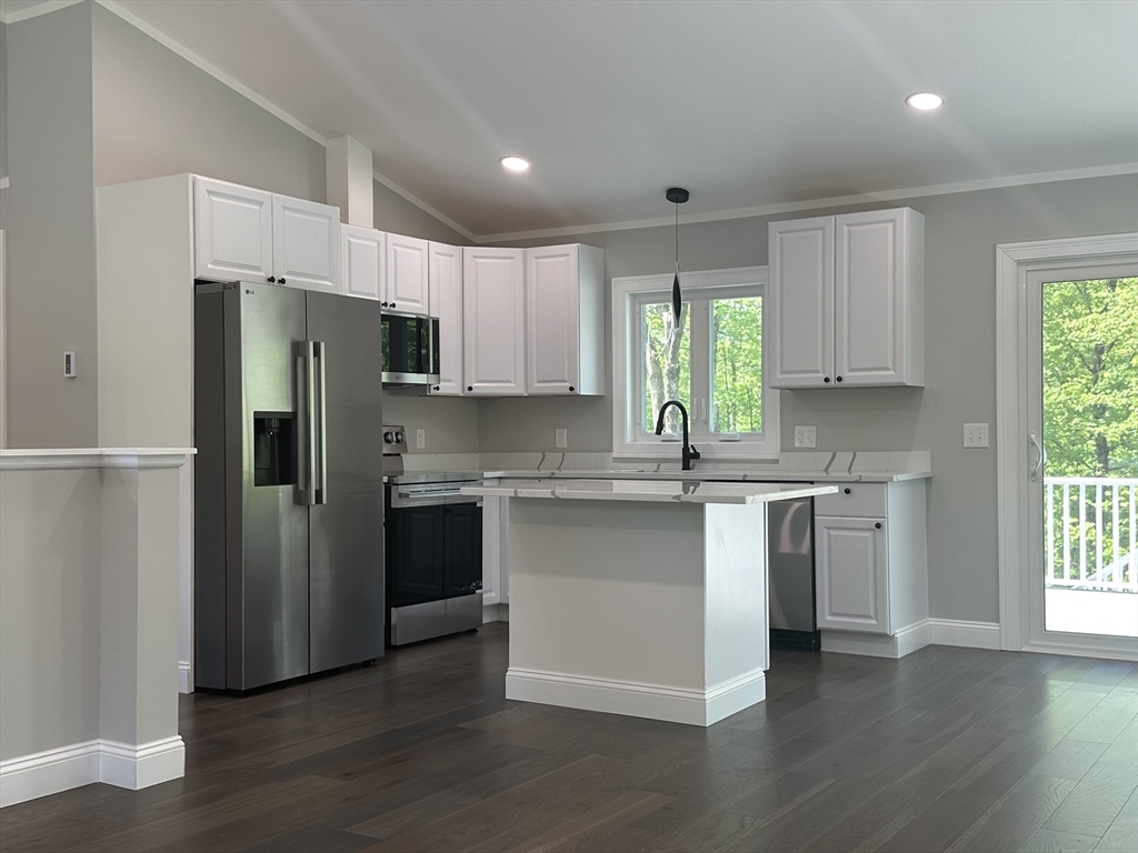 102 Wells Road Becket, MA 01223 - Photo 12 of 40 a kitchen with a refrigerator stove a sink and dishwasher with wooden floor