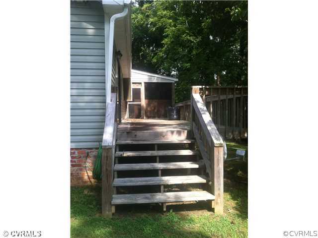 13046 Wilkinson Road Dinwiddie, VA 23841 - Photo 8 of 11 Exterior Back - Rear side of house with deck and s