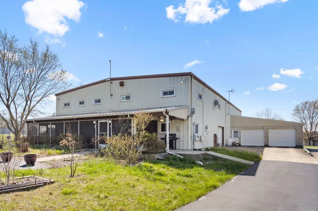 a view of a house with swimming pool and a chairs in a patio