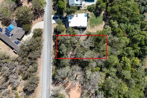 an aerial view of a house with a yard and garden