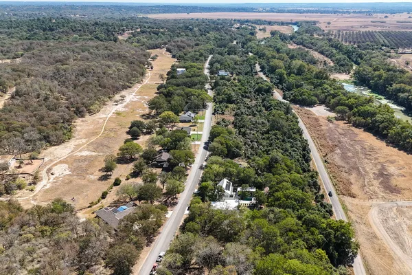 an aerial view of a house with yard