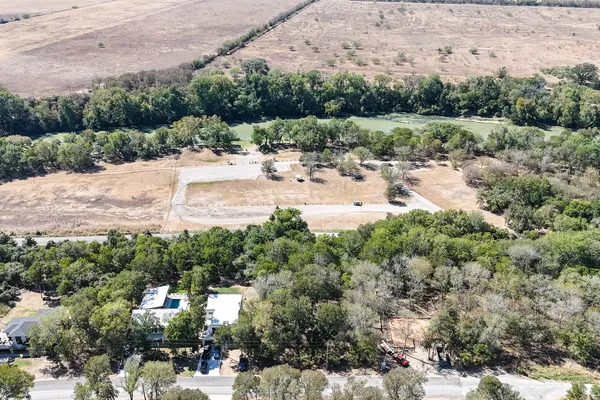 an aerial view of a houses with a yard