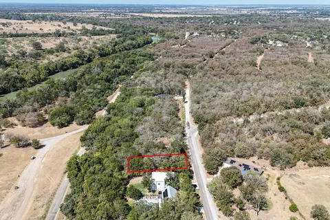 an aerial view of a houses with a yard