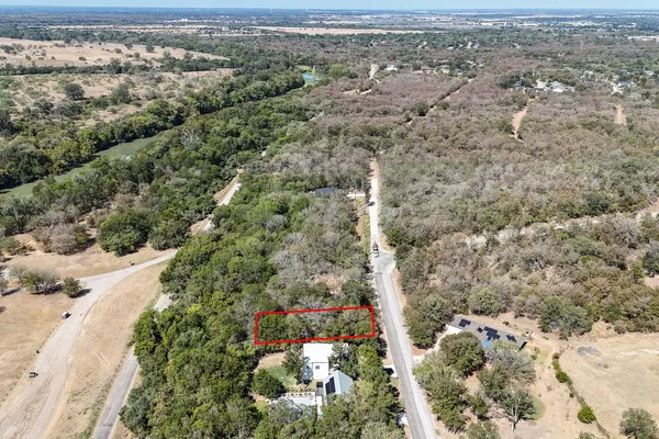 an aerial view of house with yard and mountain view in back