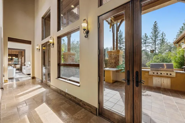 a living room with furniture and floor to ceiling windows
