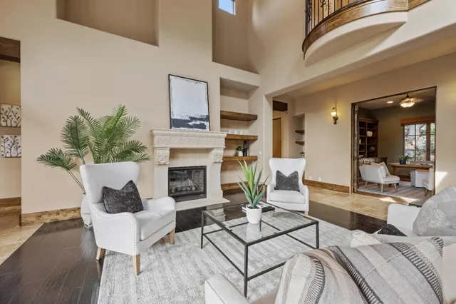 an empty room with wooden floor cabinet and windows