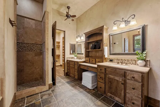 a bathroom with a granite countertop sink toilet a mirror and shower