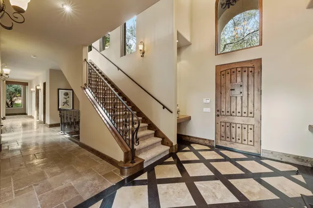 an aerial view of a house with a yard and swimming pool