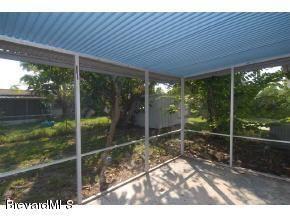 304 3rd Street Merritt Island, FL 32953 - Photo 2 of 6 a backyard of a house with lots of green space