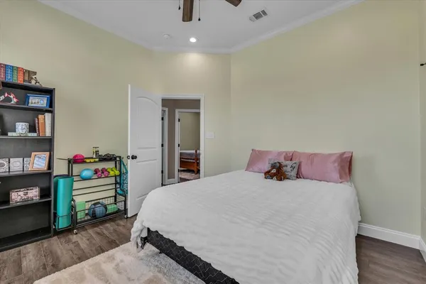 a bedroom with a bed and a book shelf