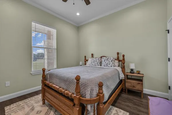 a bed sitting in a bedroom next to a window