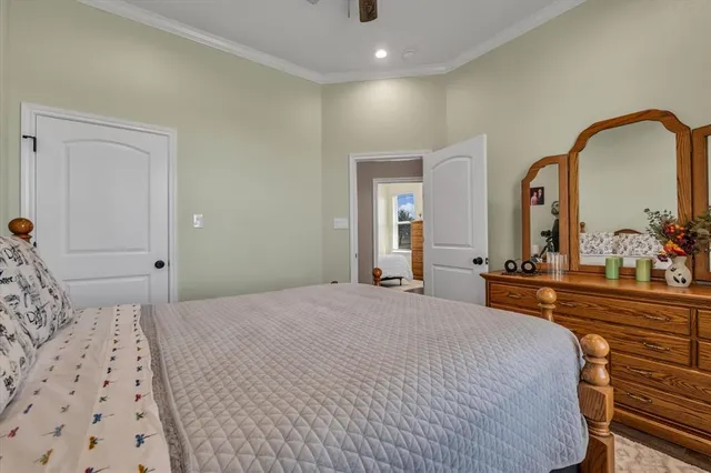 a bedroom with a large bed and a dresser