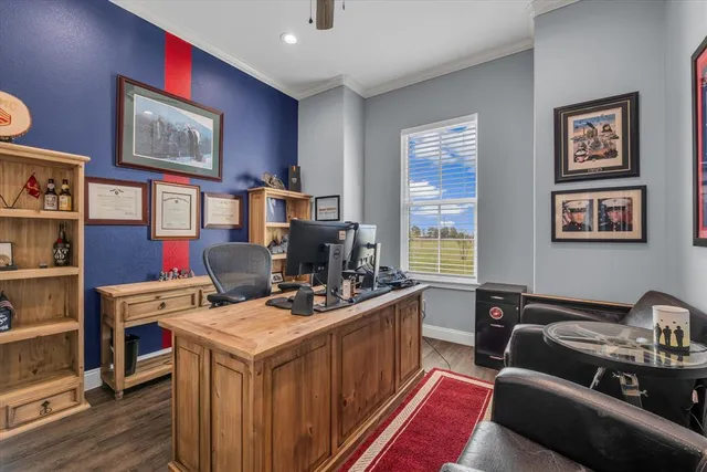 a view of a workspace with furniture and a window