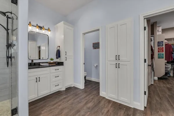 a bathroom with a double vanity sink and a mirror