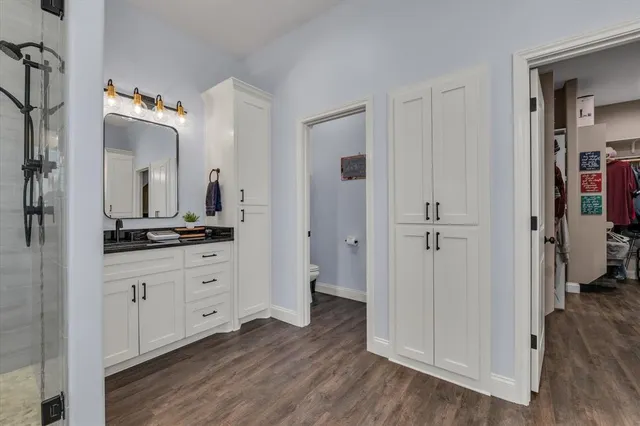 a bathroom with a double vanity sink and a mirror