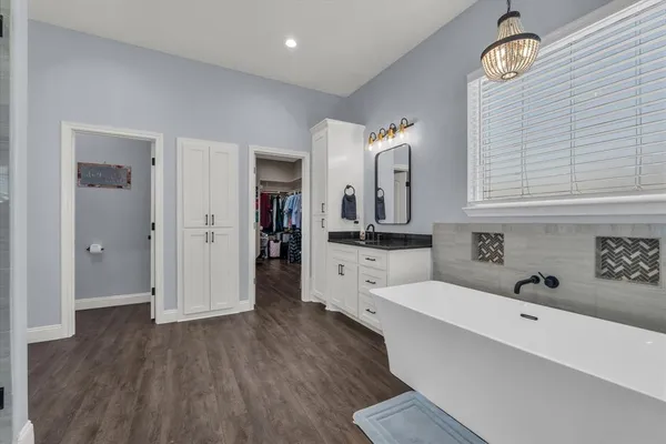 a view of a kitchen with furniture and wooden floor