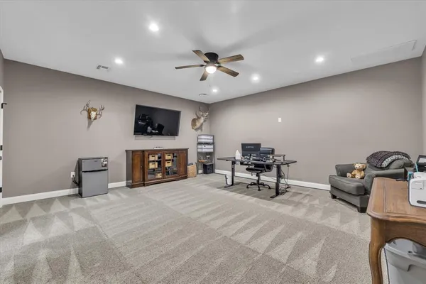a view of a livingroom with furniture and a ceiling fan