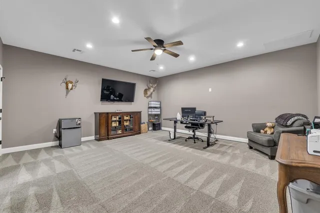 a view of a livingroom with furniture and a ceiling fan
