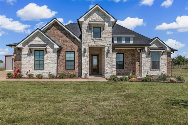 front view of a house with a yard