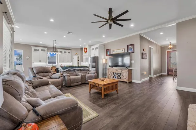 a living room with furniture and a wooden floor