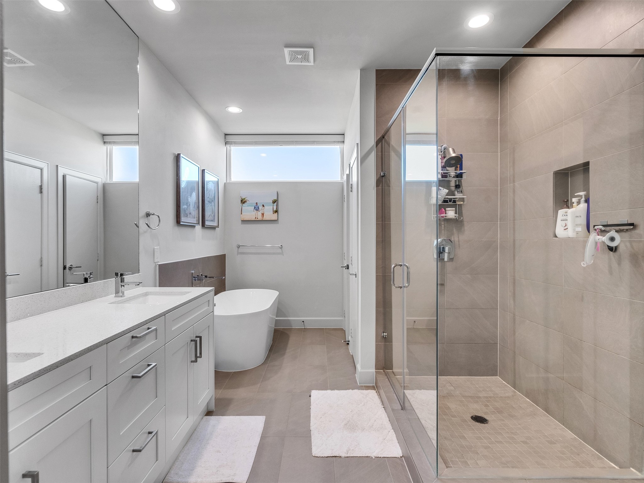 5702 Rucio Lane Houston, TX 77092 - Photo 16 of 30 a spacious bathroom with a shower sink mirror and toilet