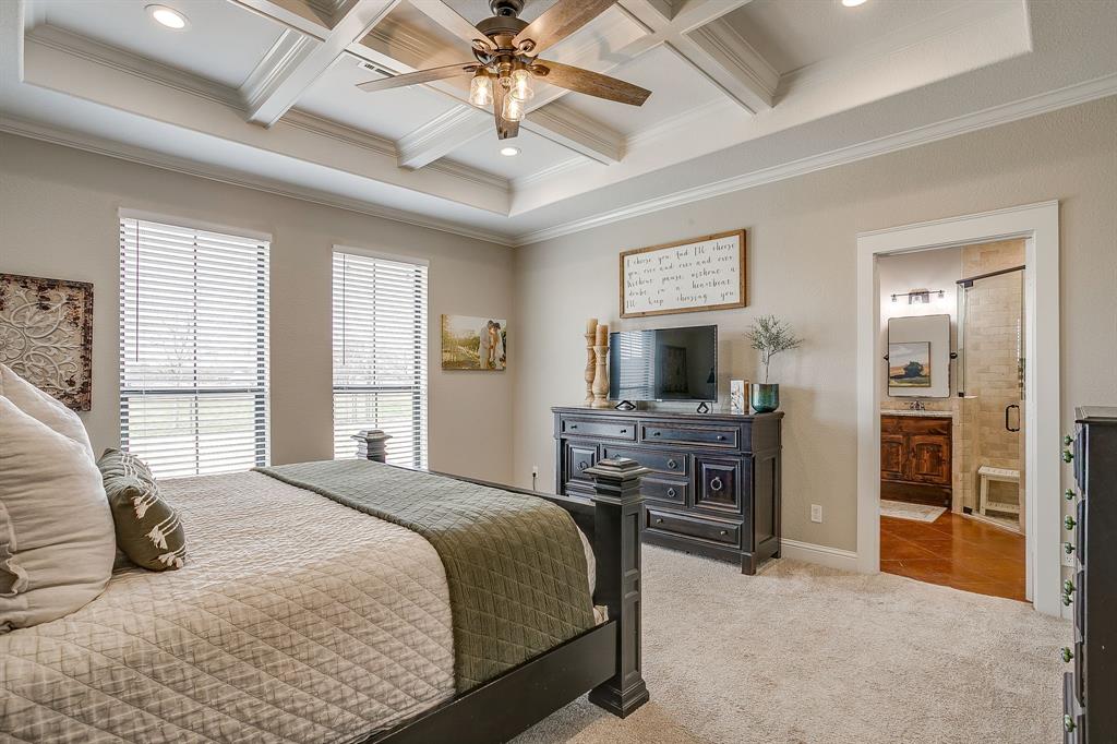 160 Goodnight Trail Rhome, TX 76078 - Photo 14 of 40 a bedroom with a bed and a flat screen tv