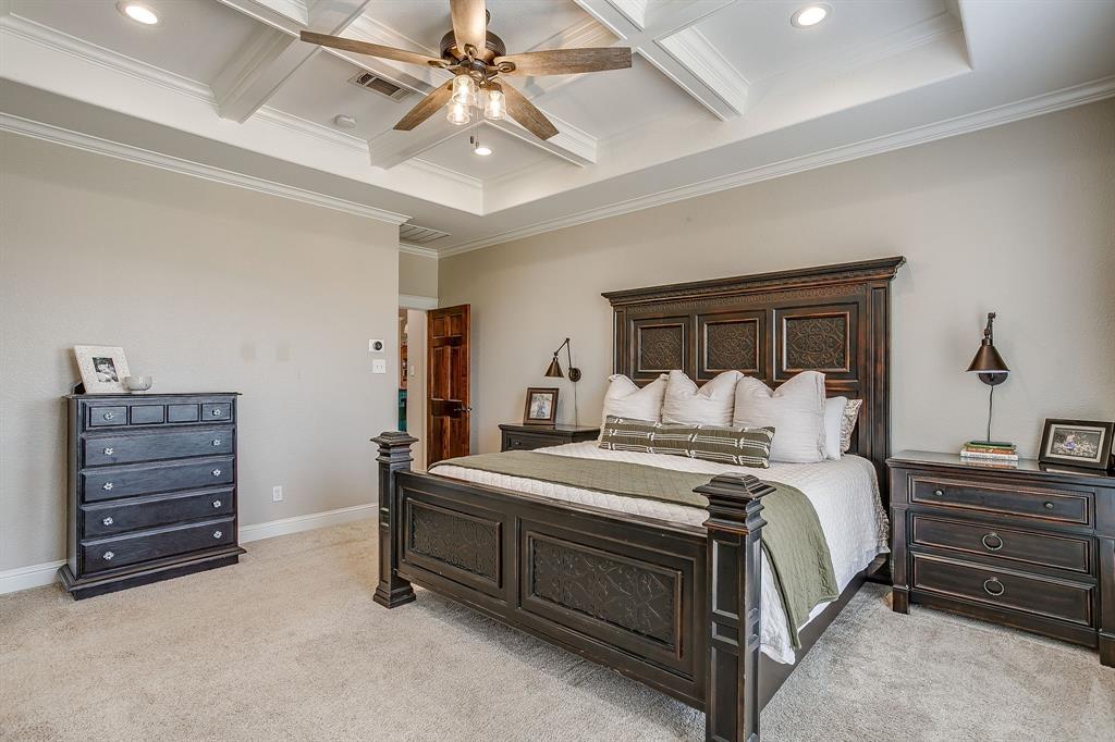 160 Goodnight Trail Rhome, TX 76078 - Photo 15 of 40 a bedroom with a bed and a chandelier