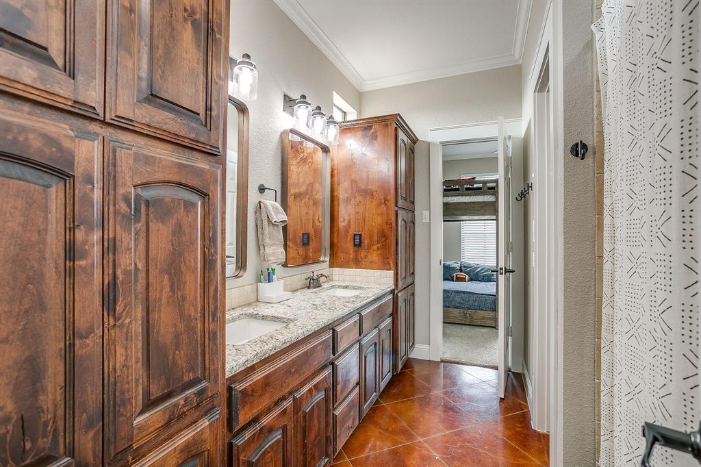 160 Goodnight Trail Rhome, TX 76078 - Photo 21 of 40 a en suite bathroom with a granite countertop sink and a mirror