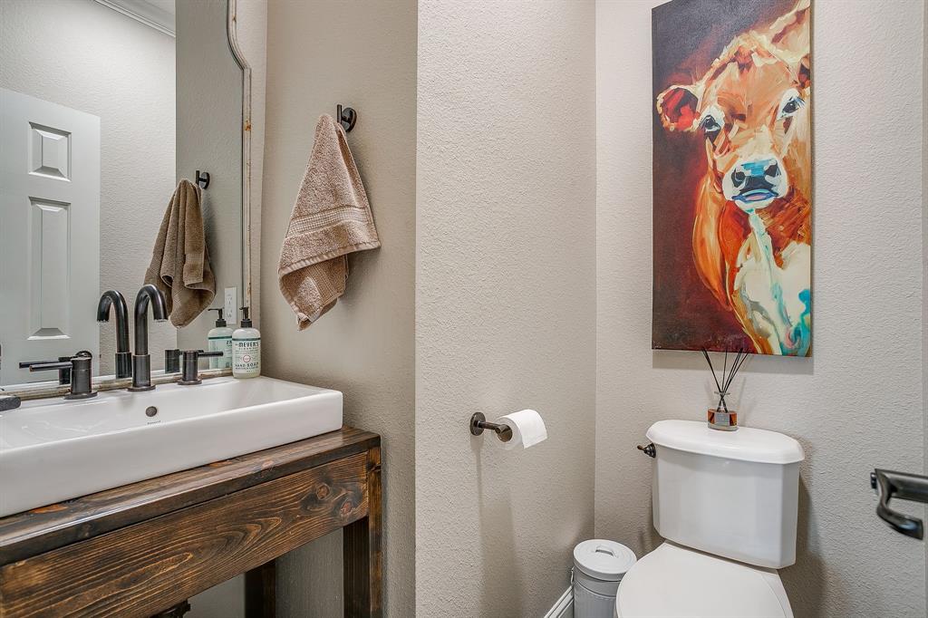 160 Goodnight Trail Rhome, TX 76078 - Photo 25 of 40 a bathroom with a toilet sink and mirror
