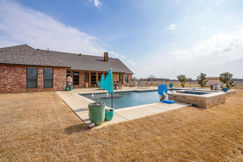 160 Goodnight Trail Rhome, TX 76078 - Photo 32 of 40 a front view of a house with swimming pool having outdoor seating