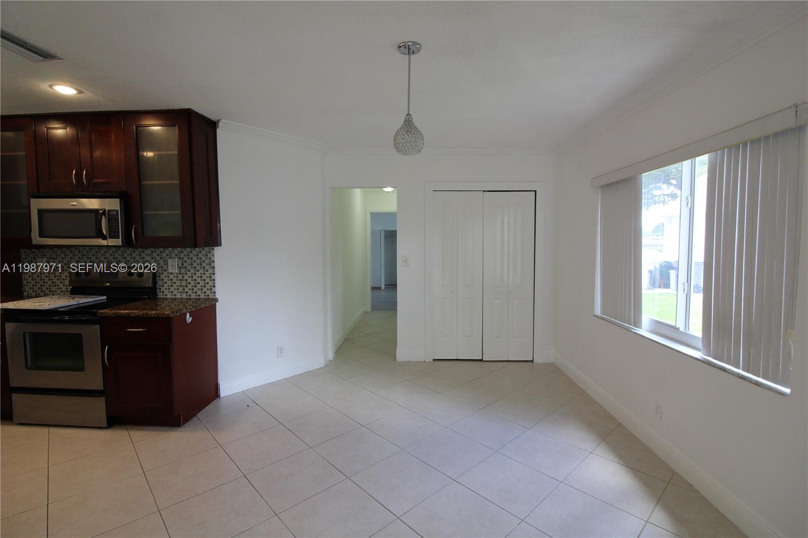 5160 Southwest 8th Street Margate, FL 33068 - Photo 12 of 23 a view of an empty room with kitchen and window