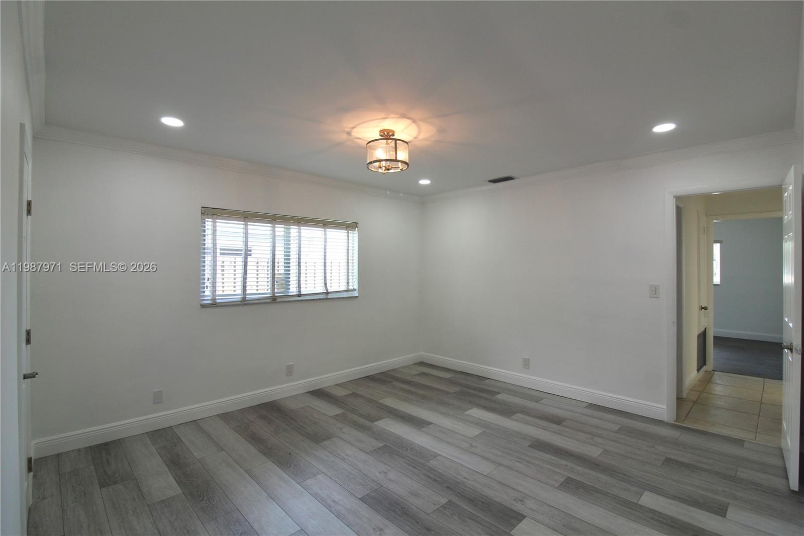 5160 Southwest 8th Street Margate, FL 33068 - Photo 18 of 23 wooden floor in an empty room with a window