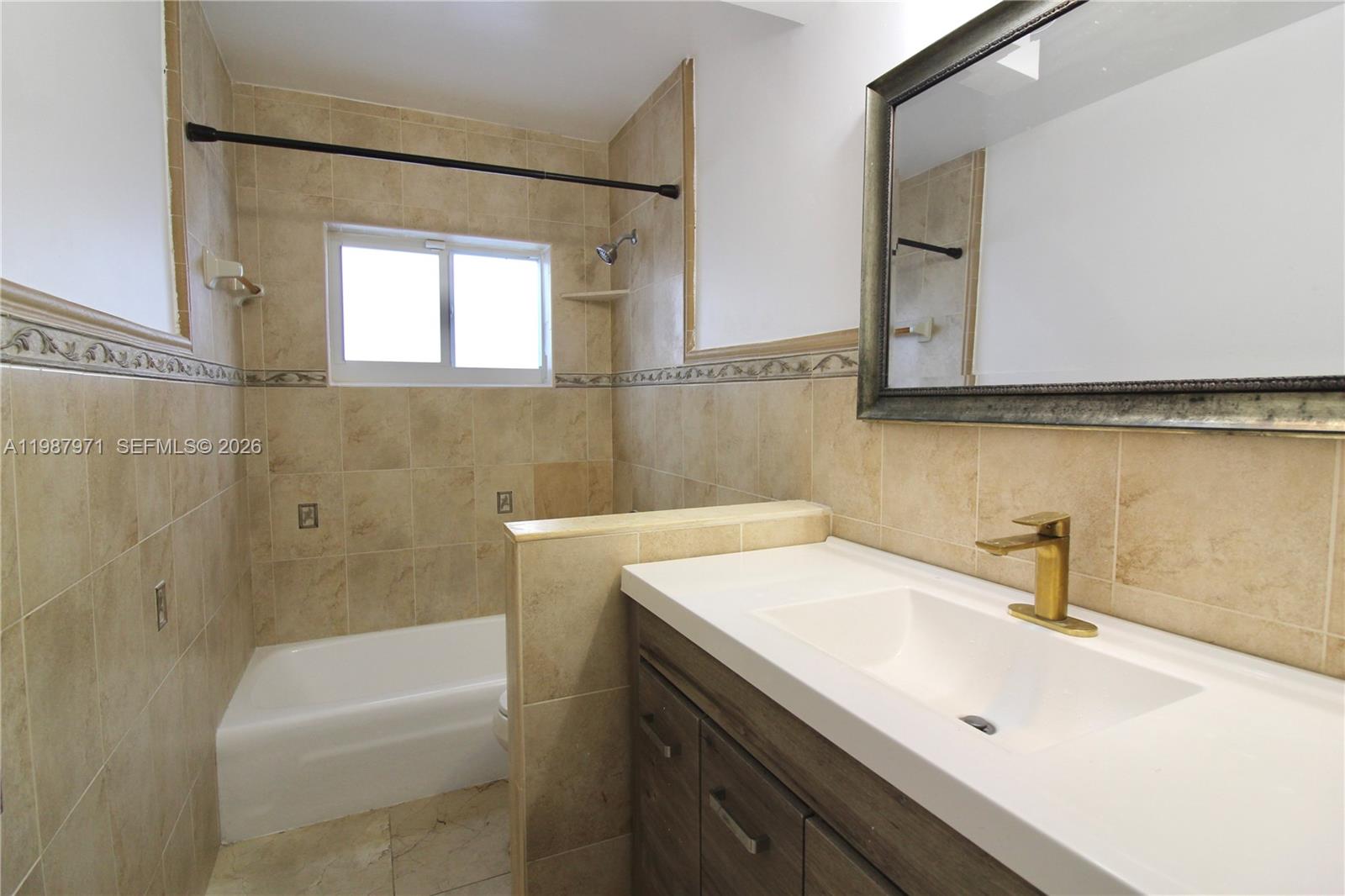 5160 Southwest 8th Street Margate, FL 33068 - Photo 20 of 23 a bathroom with a sink a mirror and a bathtub