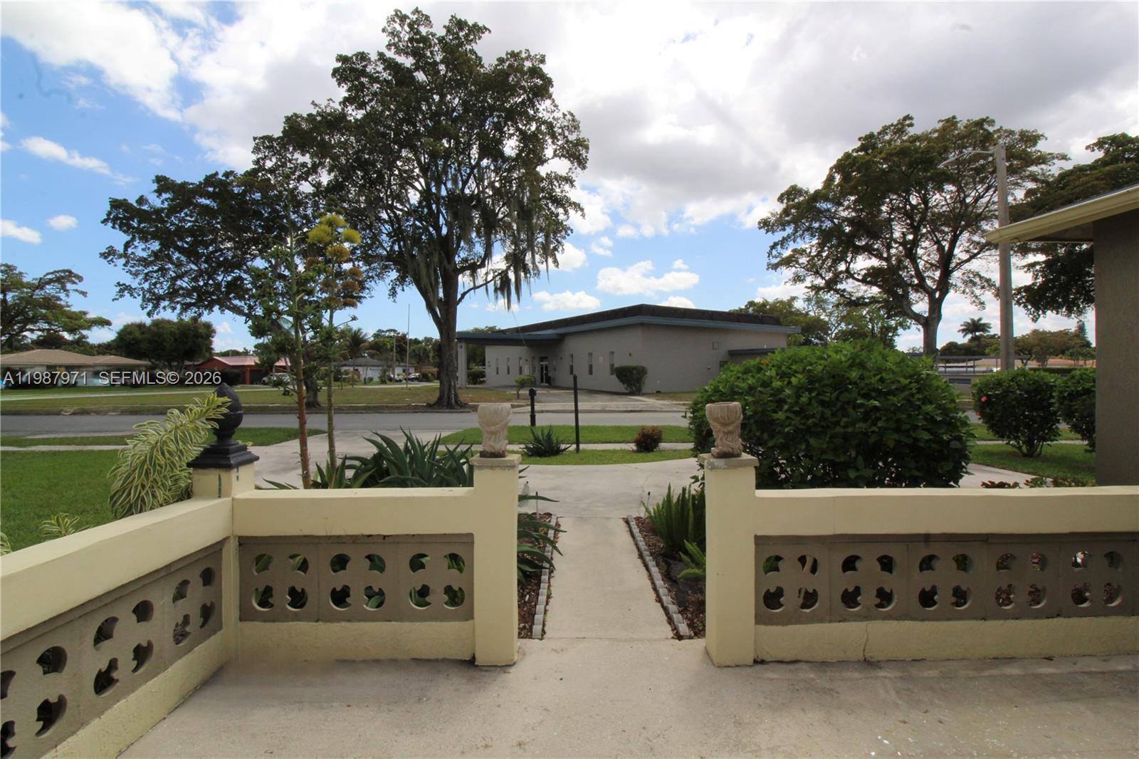 5160 Southwest 8th Street Margate, FL 33068 - Photo 2 of 23 a view of a patio with table and chairs potted plants and a large tree