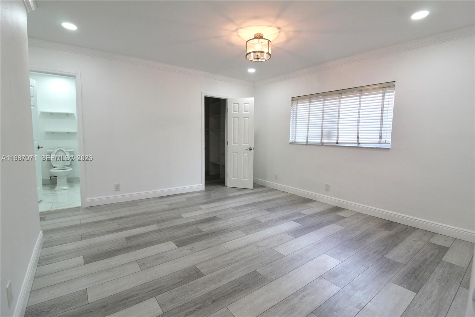 5160 Southwest 8th Street Margate, FL 33068 - Photo 6 of 23 an empty room with wooden floor and windows