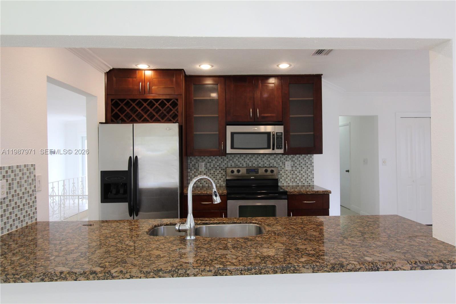 5160 Southwest 8th Street Margate, FL 33068 - Photo 10 of 23 a kitchen with stainless steel appliances granite countertop a sink and a stove top oven