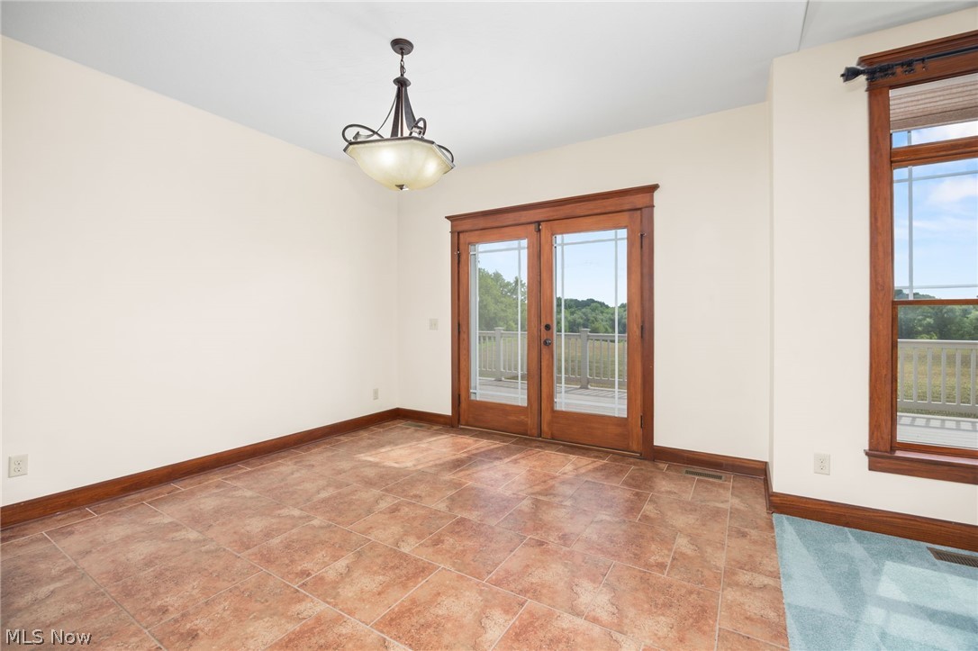 6925 River Styx Road Medina, OH 44256 - Photo 9 of 49 Interior space featuring terracotta-toned tile flooring, light-toned walls, and a decorative ceiling light fixture