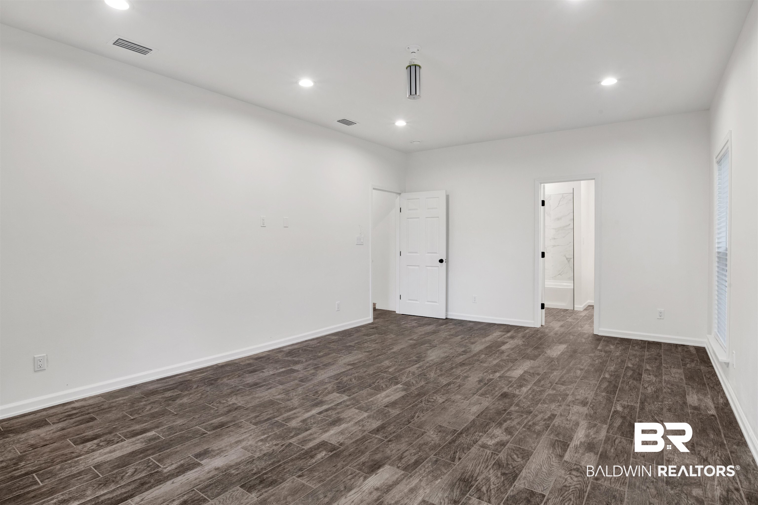 10871 Somerset Road Grand Bay, AL 36541 - Photo 9 of 31 Unfurnished room with dark hardwood / wood-style floors